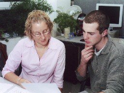 A picture of a young couple looking at a form Young couple with form